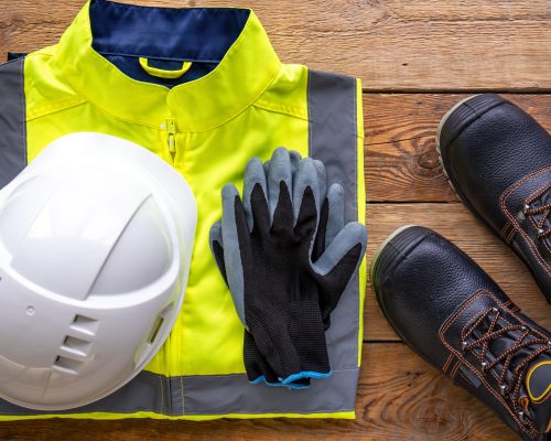Flat lay, tablet and builder uniform items, builder work and repair concept.